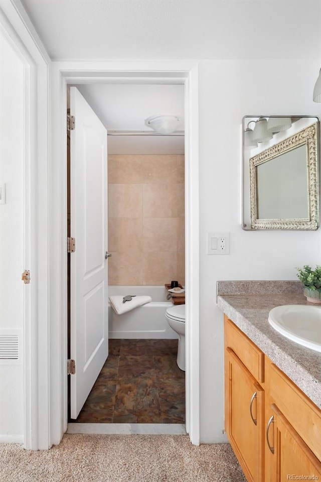 full bath featuring vanity and toilet