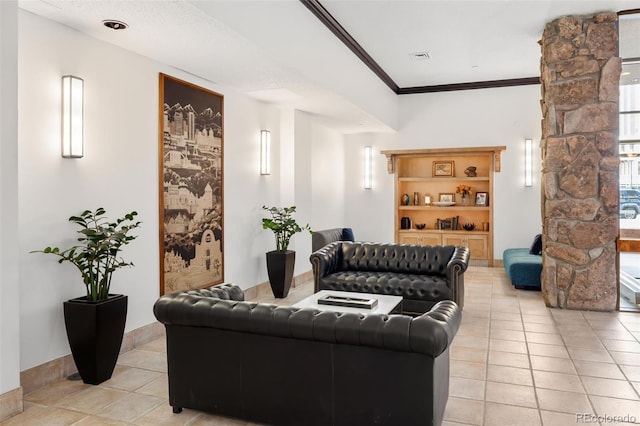 living room with crown molding, light tile patterned floors, and decorative columns