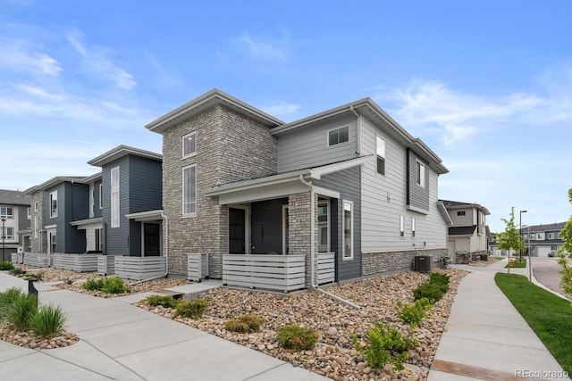 view of property exterior with central AC and a residential view