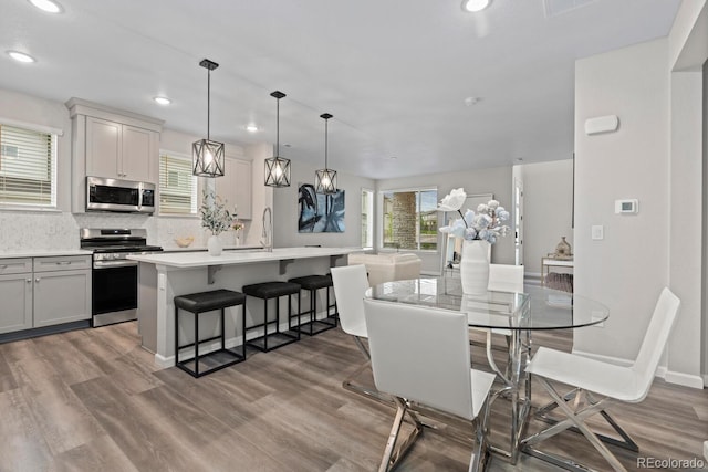 dining area featuring recessed lighting and light wood-style floors
