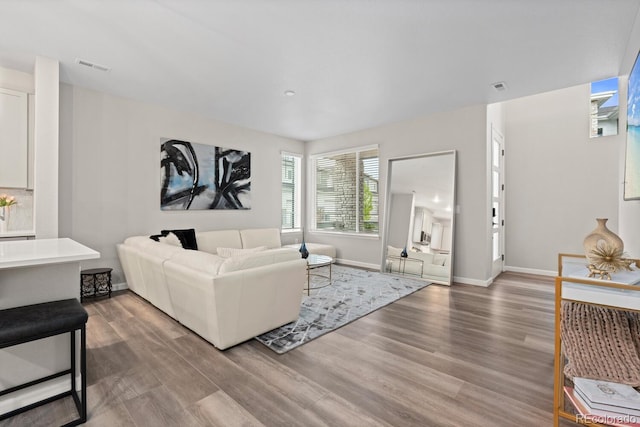 living room with light wood finished floors and baseboards
