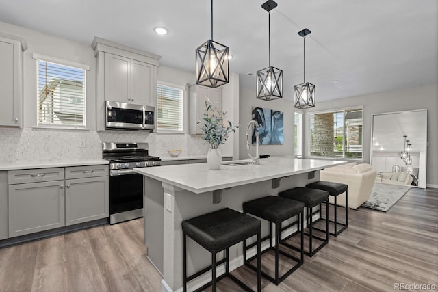 kitchen featuring stainless steel appliances, a sink, healthy amount of natural light, and recessed lighting