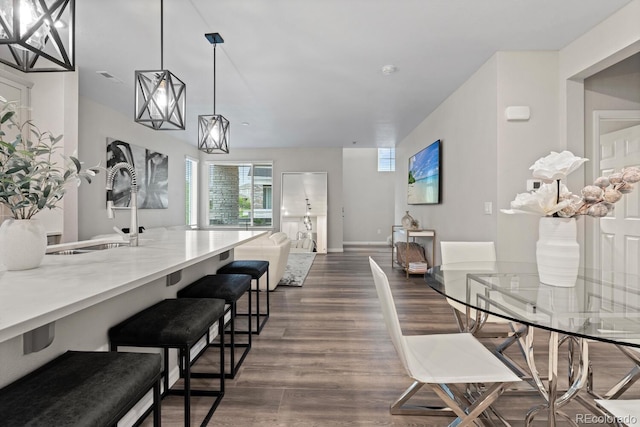 dining room with dark wood-style flooring and baseboards