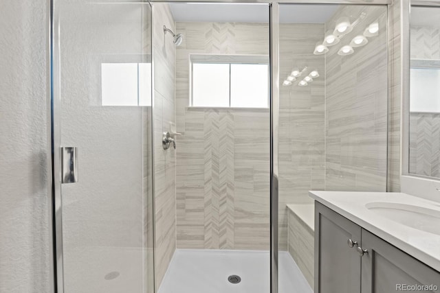 full bathroom featuring a stall shower and vanity