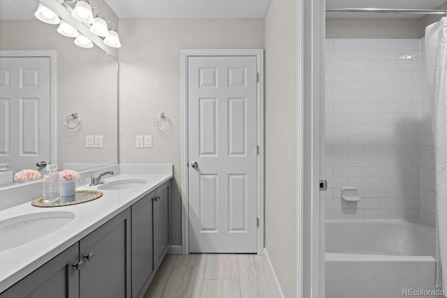 full bath featuring double vanity, baseboards, and shower / bath combo with shower curtain