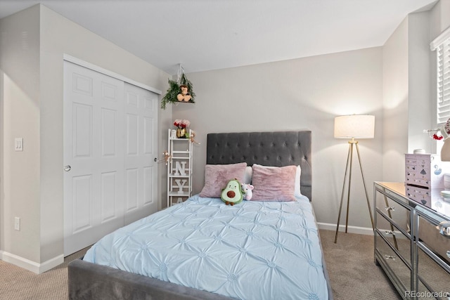 carpeted bedroom with baseboards and a closet
