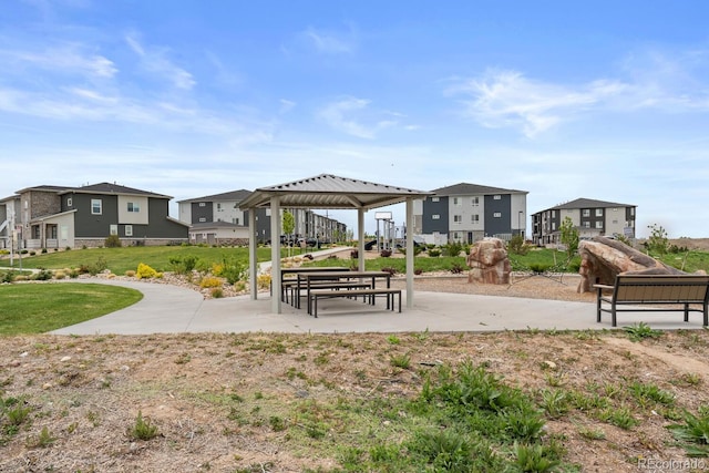 surrounding community with a gazebo, a residential view, and a lawn