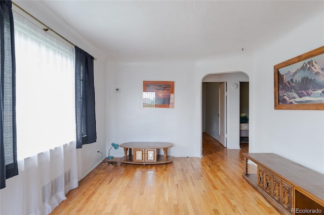 2665 W College Ave, Denver, CO 80219 - empty room featuring arched walkways and light wood finished floors