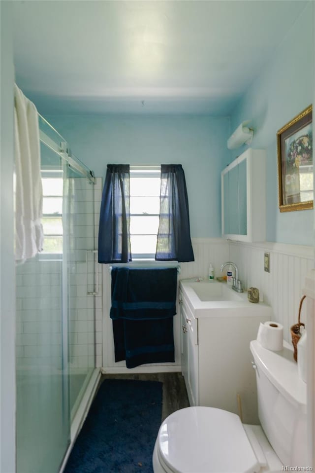 2665 W College Ave, Denver, CO 80219 - full bath featuring a shower stall, vanity, and wainscoting