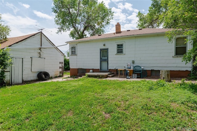 2665 W College Ave, Denver, CO 80219 - back of property with a lawn and a chimney