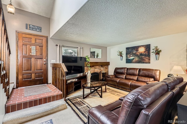 2072 S Helena St Unit B, Aurora, CO 80013 - living room featuring a textured ceiling, a brick fireplace, and carpet floors