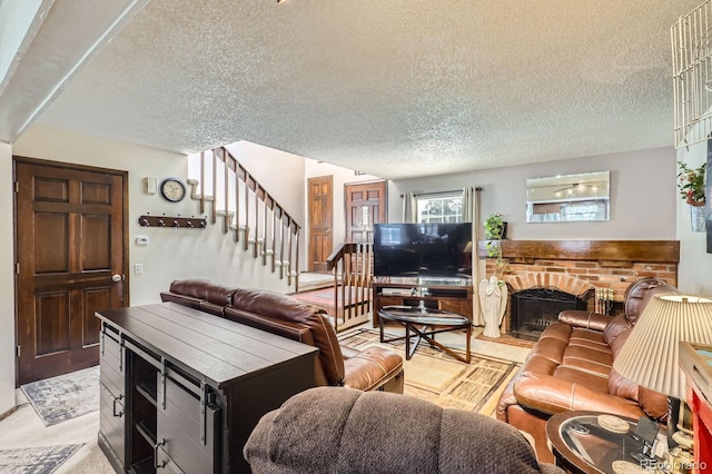 2072 S Helena St Unit B, Aurora, CO 80013 - living area featuring a textured ceiling, stairway, and a fireplace