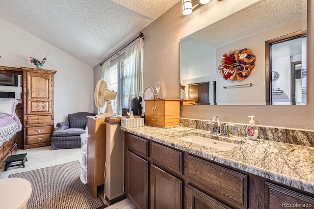 2072 S Helena St Unit B, Aurora, CO 80013 - bathroom with a textured ceiling, vaulted ceiling, and vanity