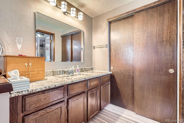 2072 S Helena St Unit B, Aurora, CO 80013 - full bath with a textured ceiling, vanity, and a textured wall