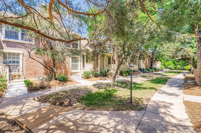 2072 S Helena St Unit B, Aurora, CO 80013 - view of property hidden behind natural elements featuring brick siding and covered porch