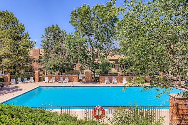 2072 S Helena St Unit B, Aurora, CO 80013 - community pool with a patio and view of scattered trees