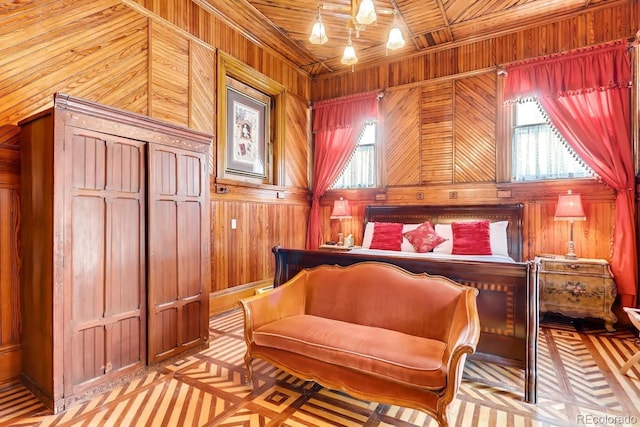 bedroom with wooden ceiling, wood walls, and an inviting chandelier