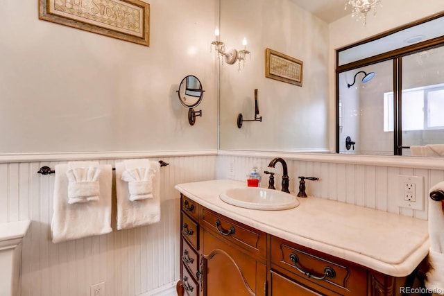 bathroom with a wainscoted wall and vanity