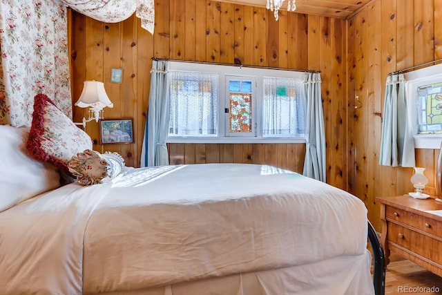 bedroom featuring wood walls