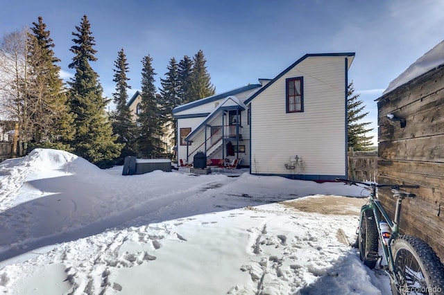 view of snow covered exterior featuring fence