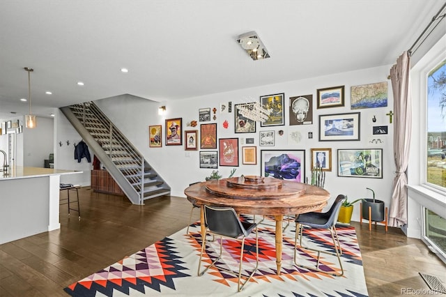 dining space with dark hardwood / wood-style floors and sink