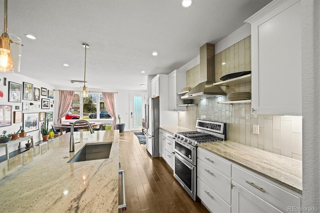 kitchen with white cabinetry, appliances with stainless steel finishes, sink, and hanging light fixtures