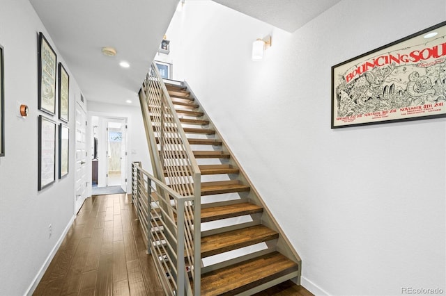 stairway with hardwood / wood-style flooring