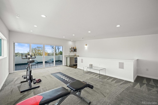 exercise area with wine cooler, sink, and carpet floors