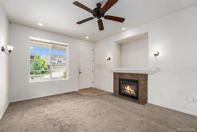 5572 Killarney St, Denver, CO 80249 - unfurnished living room featuring carpet flooring, a tiled fireplace, a ceiling fan, and recessed lighting