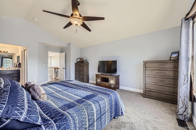 bedroom featuring vaulted ceiling, a ceiling fan, ensuite bathroom, baseboards, and carpet flooring