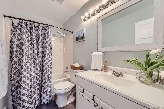 full bath featuring vanity, a textured wall, shower / tub combo, toilet, and visible vents