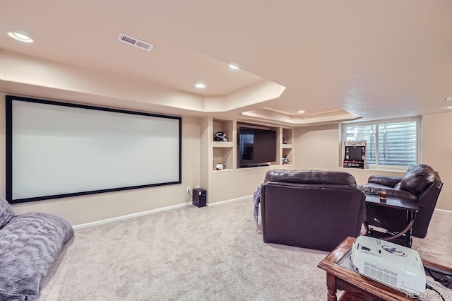 carpeted cinema room with baseboards, visible vents, recessed lighting, and a tray ceiling