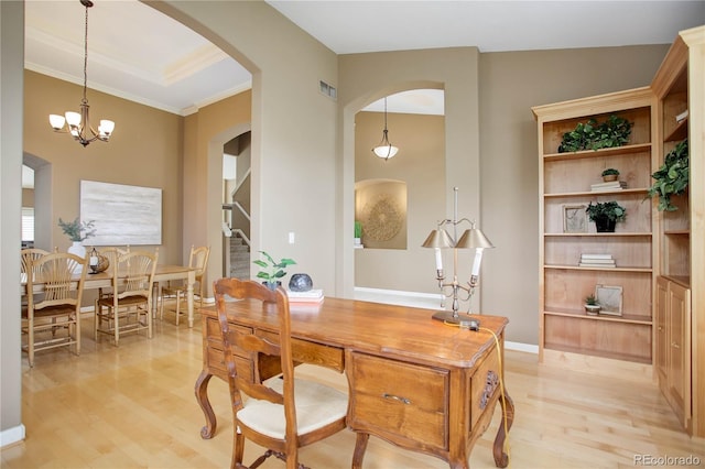 office area with ornamental molding, vaulted ceiling, a notable chandelier, and light hardwood / wood-style floors