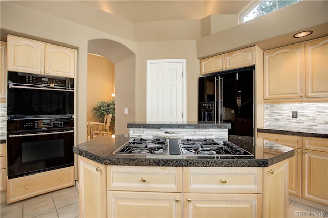 kitchen featuring black appliances, decorative backsplash, light tile patterned floors, and a center island