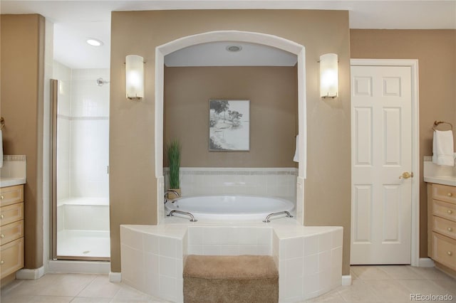 bathroom with tile patterned flooring, vanity, and independent shower and bath