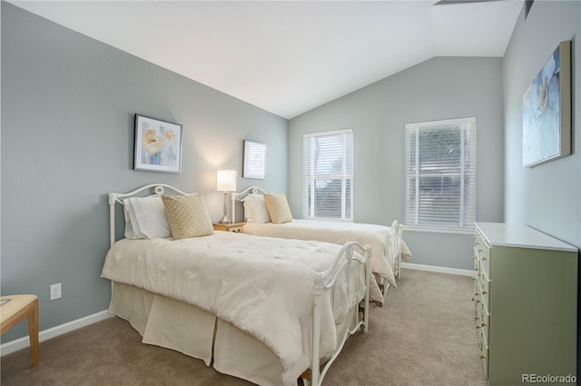 carpeted bedroom with lofted ceiling