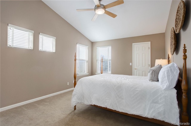 carpeted bedroom with ceiling fan and vaulted ceiling