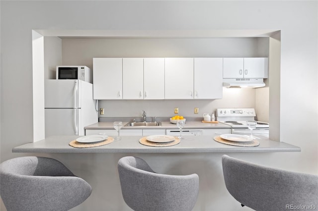 kitchen featuring white cabinets, white appliances, and sink