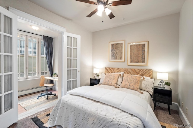 bedroom with ceiling fan, baseboard heating, and light carpet