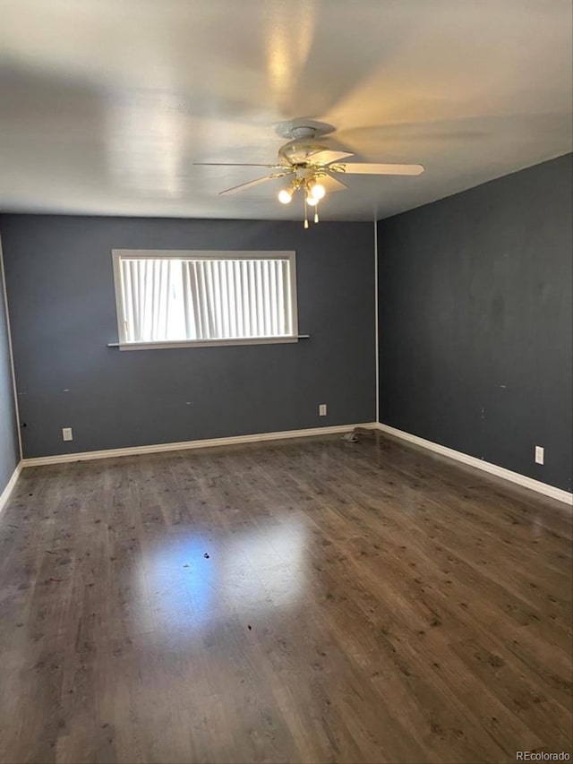 unfurnished room with ceiling fan, baseboards, and wood finished floors