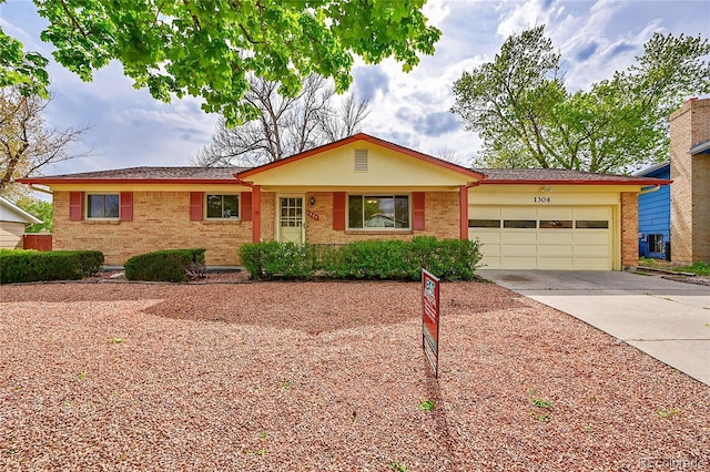1304 De Reamer Cir, Colorado Springs, CO 80915 - ranch-style house featuring brick siding, a garage, and concrete driveway