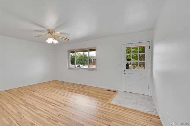 1304 De Reamer Cir, Colorado Springs, CO 80915 - foyer with healthy amount of natural light, light wood finished floors, a ceiling fan, and baseboards