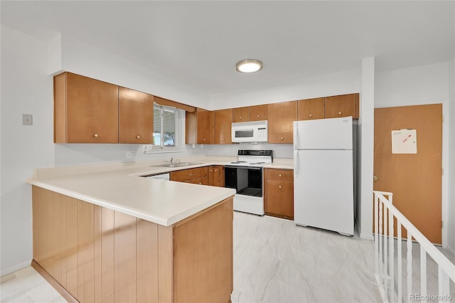 1304 De Reamer Cir, Colorado Springs, CO 80915 - kitchen with white appliances, brown cabinets, a peninsula, and a sink