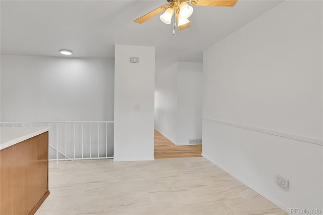 1304 De Reamer Cir, Colorado Springs, CO 80915 - empty room featuring a ceiling fan, light marble finish flooring, and baseboards