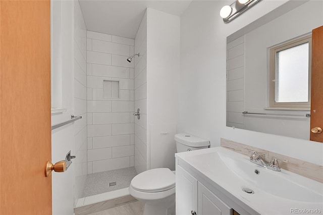 1304 De Reamer Cir, Colorado Springs, CO 80915 - bathroom featuring toilet, a tile shower, and vanity