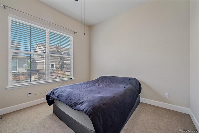 bedroom with carpet and baseboards