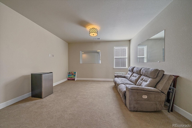 carpeted living room with baseboards