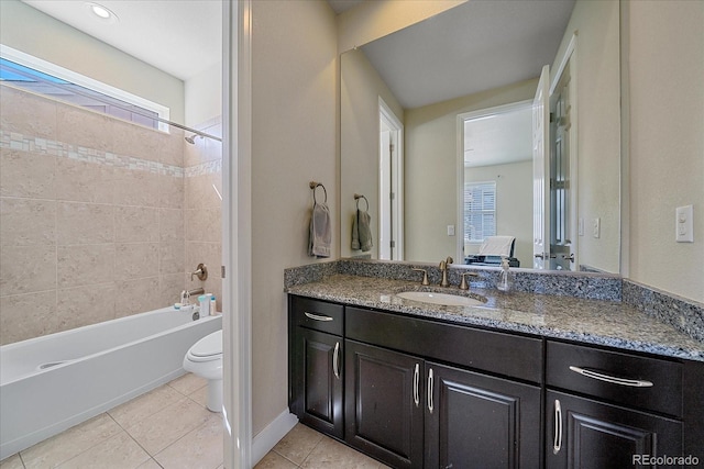 ensuite bathroom with toilet, tile patterned flooring, vanity, and shower / bathtub combination