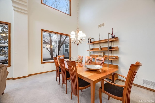 dining room featuring light carpet, visible vents, and a healthy amount of sunlight