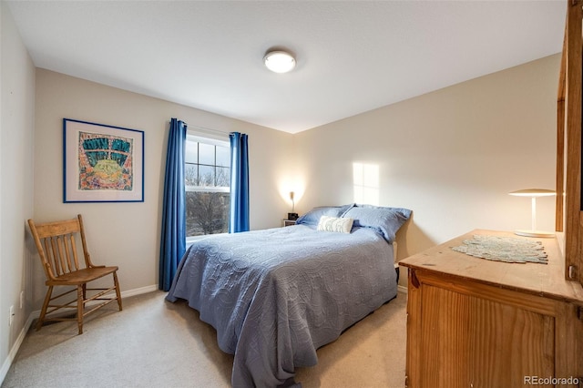 bedroom featuring light colored carpet and baseboards